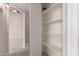 Bright hallway with carpet and open closet with plentiful shelving and view to open room at 2301 E University Dr # 393, Mesa, AZ 85213