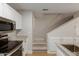 Modern kitchen features granite counters, stainless steel appliances, and convenient access to carpeted stairs at 2301 E University Dr # 393, Mesa, AZ 85213