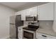 Modern kitchen with stainless steel appliances, granite countertops, and ample cabinet space at 2301 E University Dr # 393, Mesa, AZ 85213