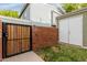 A backyard has a storage shed, a brick fence, a secure wooden gate, and a well maintained lawn at 2301 E University Dr # 393, Mesa, AZ 85213