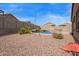 Spacious backyard with desert landscaping offering privacy, and an inviting in-ground pool at 23728 W Magnolia Dr, Buckeye, AZ 85326
