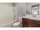 Bathroom with tub/shower and dark wood vanity at 23728 W Magnolia Dr, Buckeye, AZ 85326