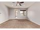 Spacious bedroom with plush carpet, neutral walls, a ceiling fan and a backyard view at 23728 W Magnolia Dr, Buckeye, AZ 85326