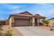 Single-story home featuring a two car garage, landscaped yard and covered porch at 23728 W Magnolia Dr, Buckeye, AZ 85326