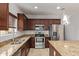 Kitchen featuring stainless steel appliances, granite countertops, and dark wood cabinets at 23728 W Magnolia Dr, Buckeye, AZ 85326