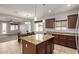 Bright kitchen with wood cabinets, granite countertops, stainless steel appliances and island at 23728 W Magnolia Dr, Buckeye, AZ 85326