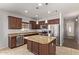 Well-lit kitchen featuring stainless steel appliances and a central island with granite countertops at 23728 W Magnolia Dr, Buckeye, AZ 85326