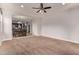 Bright living room featuring plush carpet, neutral walls, and views of the kitchen at 23728 W Magnolia Dr, Buckeye, AZ 85326