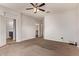 Large main bedroom featuring carpet floors, ceiling fan, and access to bathroom and walk-in closet at 23728 W Magnolia Dr, Buckeye, AZ 85326