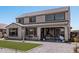 Exterior view of the home features a well-maintained yard, a patio, and ample space for outdoor activities at 2377 S 245Th Dr, Buckeye, AZ 85326