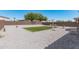 Wide backyard with neutral rock cover, enclosed by a privacy fence for seclusion and outdoor enjoyment at 2377 S 245Th Dr, Buckeye, AZ 85326