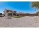 Spacious backyard featuring gravel landscaping, artificial grass, and mature trees at 2377 S 245Th Dr, Buckeye, AZ 85326