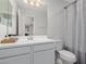 Bathroom with white cabinets, sink, toilet, window and mirror at 2377 S 245Th Dr, Buckeye, AZ 85326