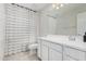 Bathroom with white cabinets, sink, toilet, shower with curtain at 2377 S 245Th Dr, Buckeye, AZ 85326