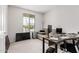 Bedroom featuring a large window, comfortable couch, and an organized workspace at 2377 S 245Th Dr, Buckeye, AZ 85326