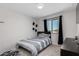 Bedroom with modern decor featuring a comfortable bed, window, and matching furniture at 2377 S 245Th Dr, Buckeye, AZ 85326