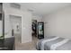 Bright bedroom with a large mirror, an organized walk-in closet, and neutral carpet at 2377 S 245Th Dr, Buckeye, AZ 85326