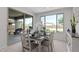 Bright dining room featuring a modern table set with backyard views from the expansive window and sliding glass door at 2377 S 245Th Dr, Buckeye, AZ 85326