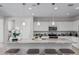 Kitchen with granite countertops, pendant lighting, stainless steel appliances, and seating at the large center island at 2377 S 245Th Dr, Buckeye, AZ 85326