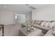 Bright living room features neutral colors, plush carpet, and a comfortable sectional sofa at 2377 S 245Th Dr, Buckeye, AZ 85326