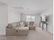 Living room with large sectional sofa, decorative pillows, and tile roof view at 2377 S 245Th Dr, Buckeye, AZ 85326