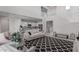 Bright living room featuring an open floor plan, modern staircase, and access to the kitchen at 2377 S 245Th Dr, Buckeye, AZ 85326