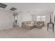 Living room with large sectional sofa, decorative pillows and an entertainment center at 2377 S 245Th Dr, Buckeye, AZ 85326