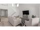Bright living room with tall ceilings, a staircase, and comfortable seating arrangement at 2377 S 245Th Dr, Buckeye, AZ 85326