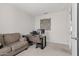Office with a comfortable sofa and a modern desk, creating a functional workspace at 2377 S 245Th Dr, Buckeye, AZ 85326
