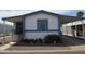 Charming home featuring a blue and white exterior, covered parking, and well-maintained landscaping at 2650 W Union Hills Dr # 230, Phoenix, AZ 85027