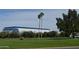 Well-maintained green golf course features mature trees and a modern building against a clear blue sky at 2650 W Union Hills Dr # 230, Phoenix, AZ 85027