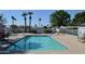 Community pool with clear blue water, lounge chairs, tables and umbrellas surrounding the area at 2650 W Union Hills Dr # 230, Phoenix, AZ 85027