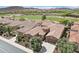 Aerial view of a home with a tile roof, desert landscaping, and a view of the community's scenic golf course at 27926 N 130Th Ave, Peoria, AZ 85383