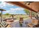 Beautiful backyard with fire pit, green grass area, patio with view of the golf course and neighborhood at 27926 N 130Th Ave, Peoria, AZ 85383