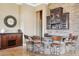 Stylish bar area with stone accents, dark wood cabinetry, a granite countertop, and seating for four at 27926 N 130Th Ave, Peoria, AZ 85383