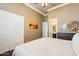 Comfortable bedroom with wood floors, ceiling fan and access to en suite bathroom at 27926 N 130Th Ave, Peoria, AZ 85383