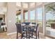 Bright breakfast nook with a round table and four chairs, surrounded by large windows with golf course views at 27926 N 130Th Ave, Peoria, AZ 85383