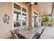 Covered patio with brick flooring, outdoor dining set and ceiling fan with view of the backyard at 27926 N 130Th Ave, Peoria, AZ 85383