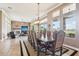 Elegant dining room featuring a large table, decorative chairs, and expansive windows with a view at 27926 N 130Th Ave, Peoria, AZ 85383
