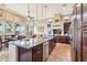 Open kitchen with a large island, granite countertops, stainless steel appliances, and scenic backyard views at 27926 N 130Th Ave, Peoria, AZ 85383
