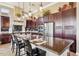 Well-appointed kitchen island with granite countertops, pendant lighting, and bar seating for four at 27926 N 130Th Ave, Peoria, AZ 85383