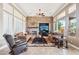 Spacious living room with stone fireplace and large windows at 27926 N 130Th Ave, Peoria, AZ 85383