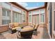 Enclosed patio with tile flooring, ample seating, and view of the exterior walls with large windows at 27926 N 130Th Ave, Peoria, AZ 85383