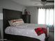 Cozy bedroom featuring a dark wood headboard, ceiling fan, and lots of natural light at 2917 S 121St Ln, Tolleson, AZ 85353
