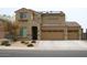 Inviting two-story home featuring a three-car garage, desert landscaping, and solar panels at 2917 S 121St Ln, Tolleson, AZ 85353