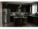 Modern kitchen with dark cabinets, stainless steel appliances, and granite countertops at 2917 S 121St Ln, Tolleson, AZ 85353