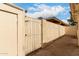 Backyard showing a secure gate and tall privacy fence with desert landscaping at 3109 W Loma Ln, Phoenix, AZ 85051