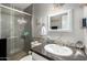 Updated bathroom with a glass enclosed shower, granite countertop and mosaic tile backsplash at 3109 W Loma Ln, Phoenix, AZ 85051
