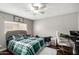 Comfortable bedroom with a ceiling fan, workspace, and laminate flooring at 3109 W Loma Ln, Phoenix, AZ 85051