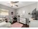 Cute bedroom featuring a ceiling fan, desk, TV, and laminate flooring at 3109 W Loma Ln, Phoenix, AZ 85051